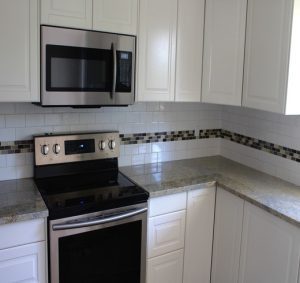 granite countertop white cabinets in a kitchen